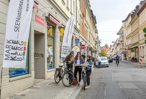 Eingang der Tourist-Info-Markkleeberg-Leipziger-Neuseenland mit 3 Radfahrerinnen