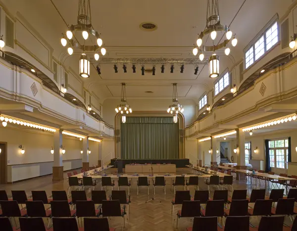 Blick in den Großen Lindensaal. Hier sind Stühle und Tische für eine Versammlung aufgebaut.